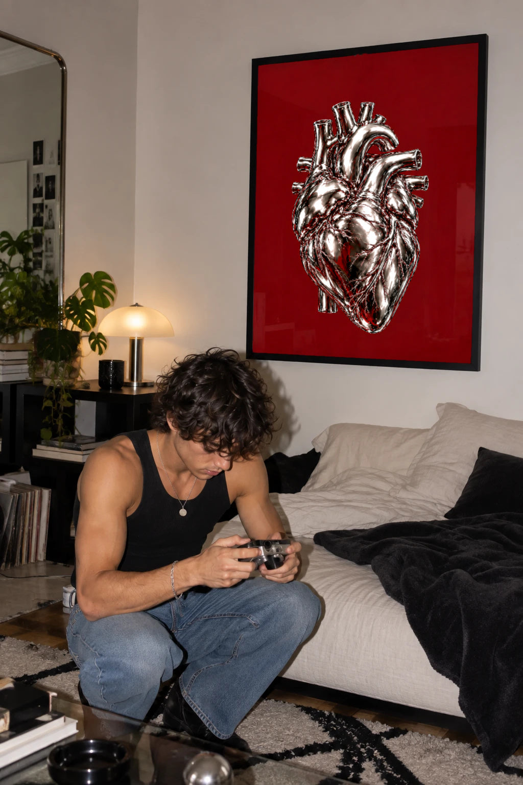 Heart of Steel — chrome anatomical heart poster on burgundy in a black frame in a living room by WallDrip